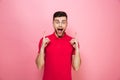 Portrait of a happy young man pointing fingers up Royalty Free Stock Photo