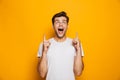 Portrait of a happy young man pointing fingers up Royalty Free Stock Photo