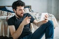 Portrait of a happy young man relaxing and watching a TV show on a tablet computer Royalty Free Stock Photo