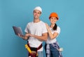 Portrait Of Happy Man And Woman In Hard Hats With Laptop Computer Royalty Free Stock Photo