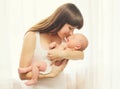 Portrait of happy young mother and baby on hands Royalty Free Stock Photo