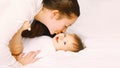 Portrait of happy young mother and cute baby lying on the bed at home together Royalty Free Stock Photo