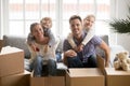 Portrait of happy adopted kids embracing parents on moving day Royalty Free Stock Photo