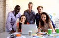 Portrait of happy young people in a meeting looking at camera and smiling. Young designers working together on creative Royalty Free Stock Photo