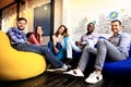 Portrait of happy young people in a meeting looking at camera and smiling. Young designers working together on a Royalty Free Stock Photo