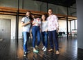 Portrait of happy young people in a meeting looking at camera and smiling. Young designers working together on a Royalty Free Stock Photo