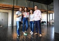 Portrait of happy young people in a meeting looking at camera and smiling. Young designers working together on a Royalty Free Stock Photo