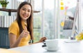 Portrait happy young programmer Asian woman work at start up technology office and using computer for coding application program Royalty Free Stock Photo