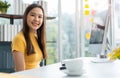 Portrait happy young programmer Asian woman work at start up technology office and using computer for coding application program Royalty Free Stock Photo