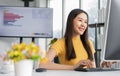 Portrait happy young programmer Asian woman work at start up technology office and using computer for coding application program Royalty Free Stock Photo