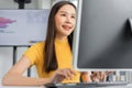 Portrait happy young programmer Asian woman work at start up technology office and using computer for coding application program Royalty Free Stock Photo