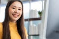 Portrait happy young programmer Asian woman work at start up technology office and using computer for coding application program Royalty Free Stock Photo