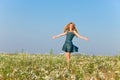 Portrait happy of the young slender blonde in the field of camomiles in a sunny day Royalty Free Stock Photo