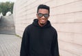 Portrait happy young smiling african man wearing black hoodie, sunglasses