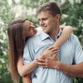 Portrait happy young smiling couple in love over a flowering spring garden Royalty Free Stock Photo