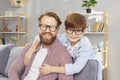 Portrait of happy young smiling father with cute little child boy wearing eyeglasses. Royalty Free Stock Photo