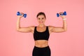 Portrait Of Happy Young Sporty Woman Training With Two Blue Dumbbells Royalty Free Stock Photo