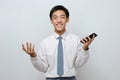 Portrait of happy young student with smiley face holding mobile phone Royalty Free Stock Photo