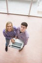 Portrait of happy young students using laptop Royalty Free Stock Photo