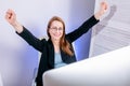 Portrait of happy young successful businesswoman celebrate something with arms up at office. Positive emotion. Big deal, promotion Royalty Free Stock Photo