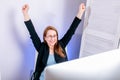 Portrait of happy young successful businesswoman celebrate something with arms up at office. Positive emotion. Big deal, promotion Royalty Free Stock Photo