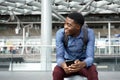 Happy young travel man sitting on suitcase with mobile phone Royalty Free Stock Photo