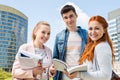 Portrait of happy young university students studying outdoors Royalty Free Stock Photo