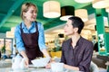 Young Waitress Bringing Food to Female Guest Royalty Free Stock Photo