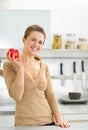 Portrait of happy young woman apple in kitchen