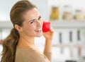 Portrait of happy young woman apple in kitchen