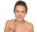 Portrait of happy young woman applying lip gloss Royalty Free Stock Photo