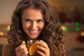 Portrait of happy young woman with cup of ginger tea Royalty Free Stock Photo