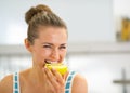 Portrait of happy young woman eating apple Royalty Free Stock Photo