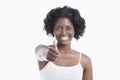 Portrait of a happy young woman gesturing thumbs up over white background Royalty Free Stock Photo