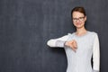 Portrait of happy young woman giving thumb down sign of disapproval Royalty Free Stock Photo