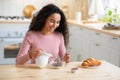 Portrait Of Happy Young Woman Having Breakfast In Kitchen, Eating Muesli Royalty Free Stock Photo