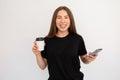 Portrait of happy young woman holding coffee cup and smartphone Royalty Free Stock Photo