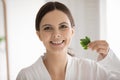 Portrait of happy young woman holding fresh green parsley leaves Royalty Free Stock Photo