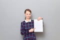 Portrait of happy young woman holding white blank paper sheet Royalty Free Stock Photo