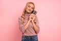 Portrait of a happy young woman hugging chocolate bar isolated over pink background Royalty Free Stock Photo