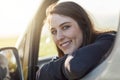 Im in the mood for a roadtrip. Portrait of a happy young woman looking out of the window of her car while out on a Royalty Free Stock Photo