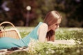 Portrait of happy young woman having rest on picnic in park Royalty Free Stock Photo