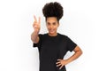 Portrait of happy young woman making victory gesture Royalty Free Stock Photo