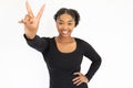 Portrait of happy young woman making victory gesture Royalty Free Stock Photo