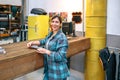 Portrait of happy young woman owner standing in front of store counter with copy space Royalty Free Stock Photo