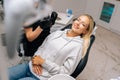 Portrait of happy young woman patient with perfect white teeth and smile satisfied after dental treatment in dentist Royalty Free Stock Photo