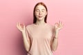 Portrait happy young woman in pink shirt doing yoga Royalty Free Stock Photo