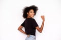 Portrait of happy young woman showing bicep and smiling Royalty Free Stock Photo