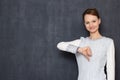 Portrait of happy young woman showing thumb down in dislike gesture Royalty Free Stock Photo