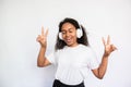 Portrait of happy young woman singing and making victory gesture Royalty Free Stock Photo